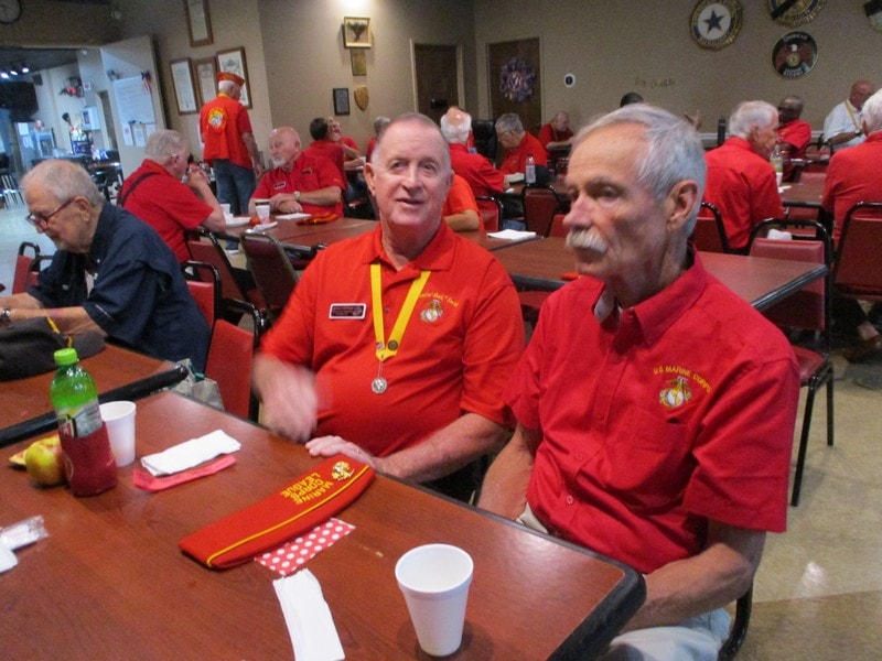 Senior veterans gathering in red uniforms