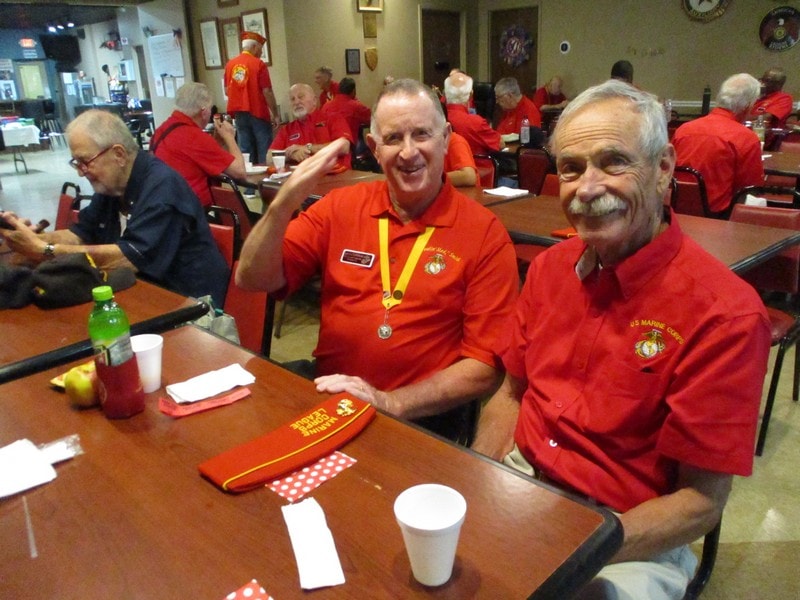 Senior veterans in red uniforms at gathering