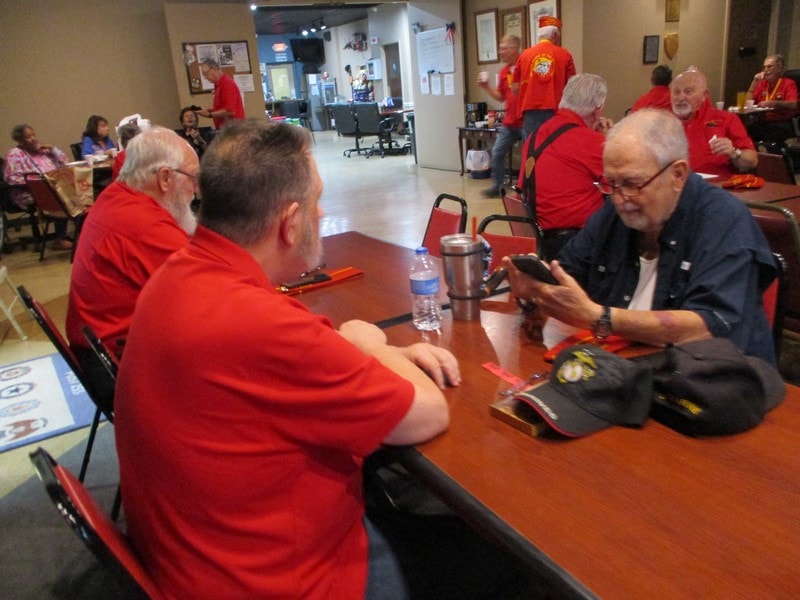 Group gathering wearing red shirts indoors