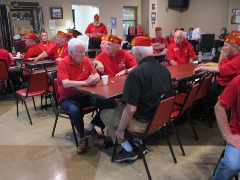 Group of members in red shirts meeting indoors