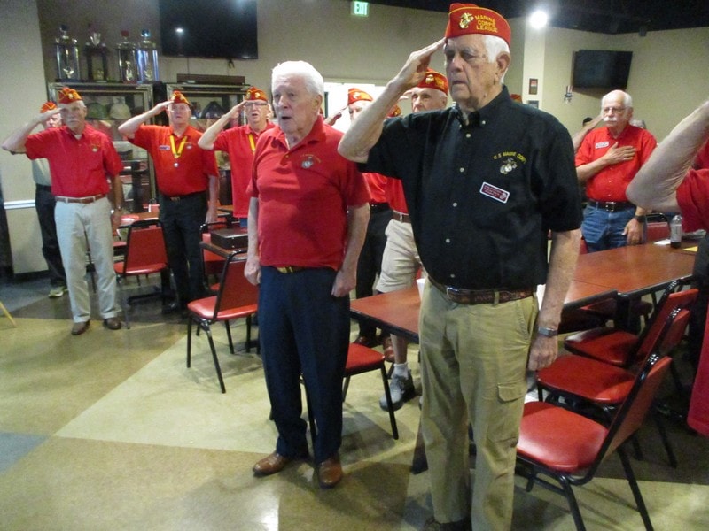Veterans in red uniforms at ceremony